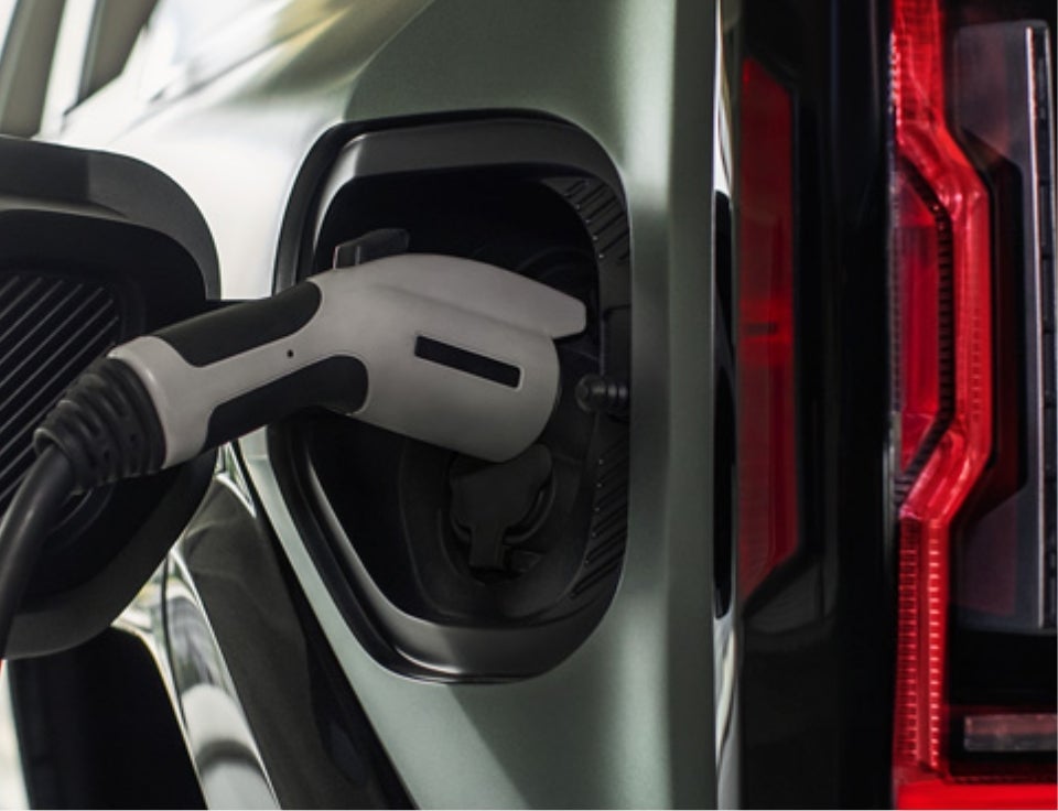 Close up of charging port with charger plugged in on a GMC Hummer EV SUV - Mataga GMC in Stockton CA